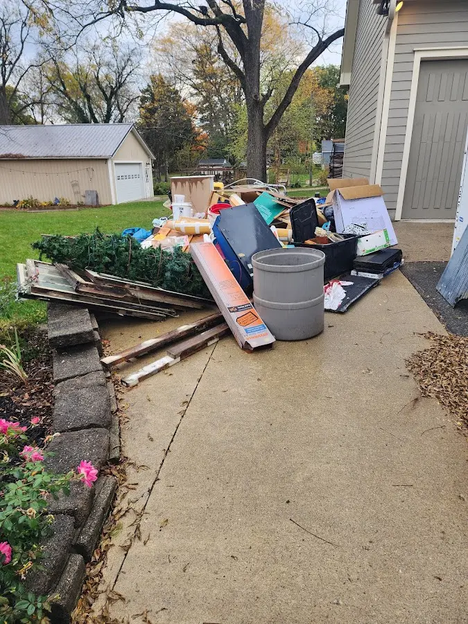 Dumpster being loaded with debris for Estate Cleanout Dumpster Rental in Bountiful